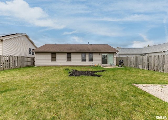 rear view of property with a lawn