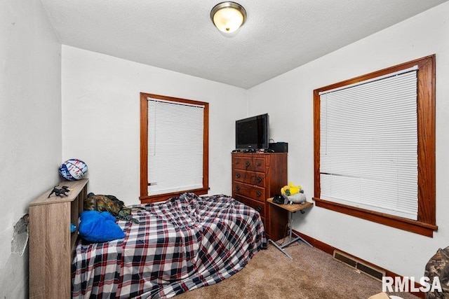 carpeted bedroom with a textured ceiling