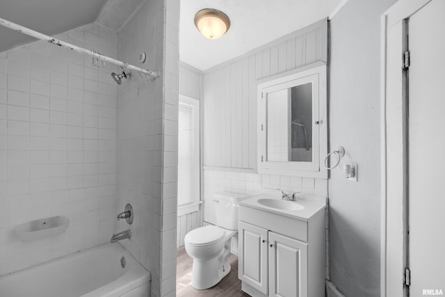 full bathroom featuring vanity, toilet, wood-type flooring, and tiled shower / bath combo