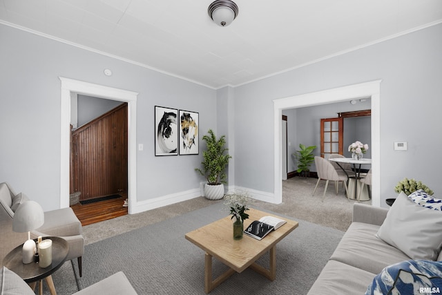 carpeted living room featuring ornamental molding