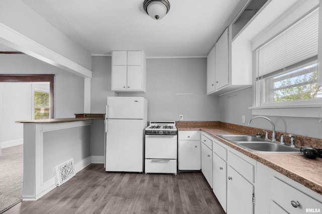 kitchen with white appliances, white cabinets, crown molding, sink, and dark hardwood / wood-style floors