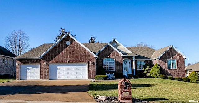 view of front facade with driveway, brick siding, an attached garage, and a front yard