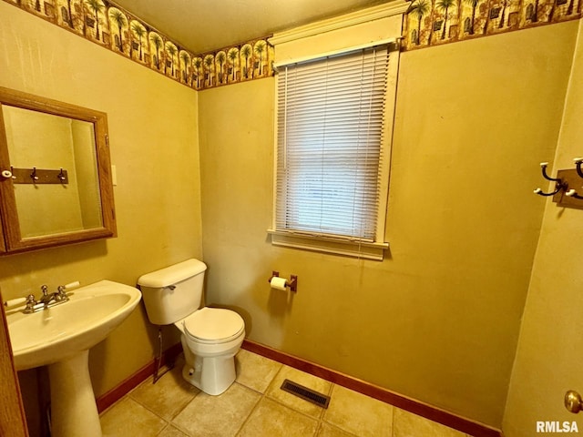 bathroom with tile patterned flooring, toilet, and sink