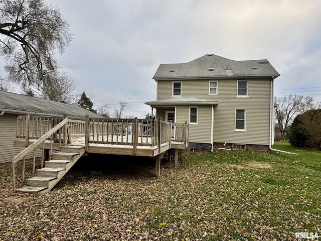 rear view of house with a yard and a wooden deck