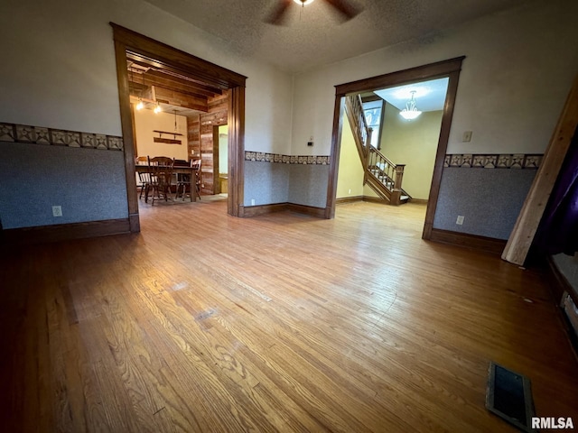 spare room featuring ceiling fan, wood-type flooring, and a textured ceiling