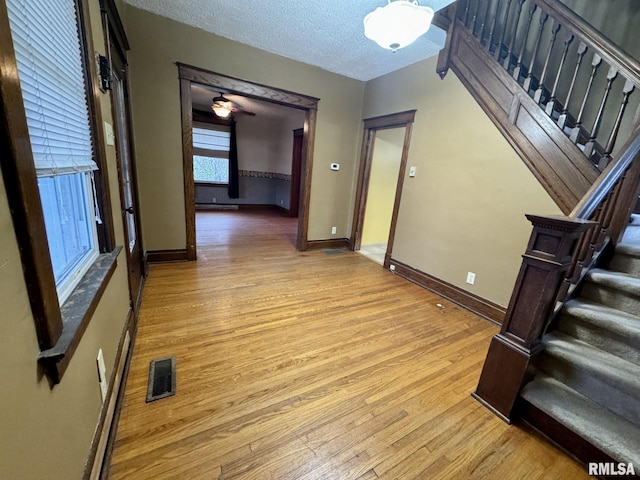 interior space with light hardwood / wood-style flooring and a textured ceiling