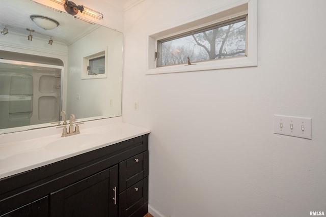 bathroom with crown molding and vanity