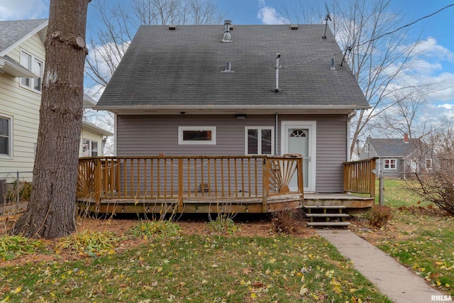 back of house featuring a deck and a yard