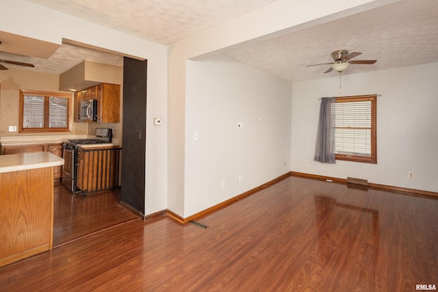 spare room with ceiling fan, dark hardwood / wood-style flooring, and a textured ceiling