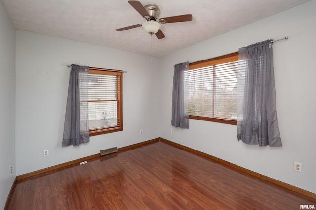 unfurnished room featuring dark hardwood / wood-style floors and ceiling fan