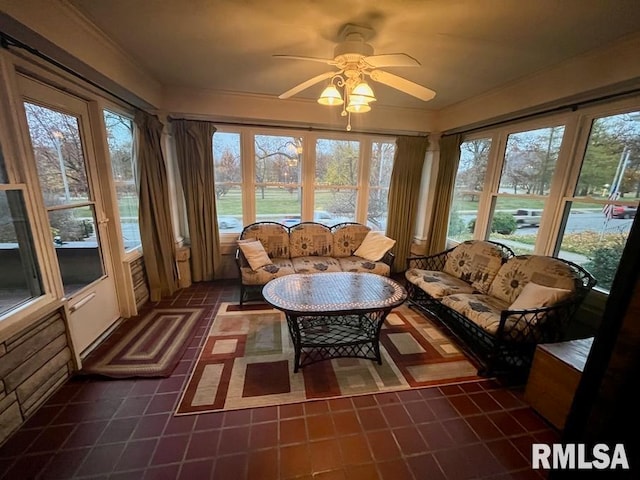 sunroom / solarium with ceiling fan and a healthy amount of sunlight