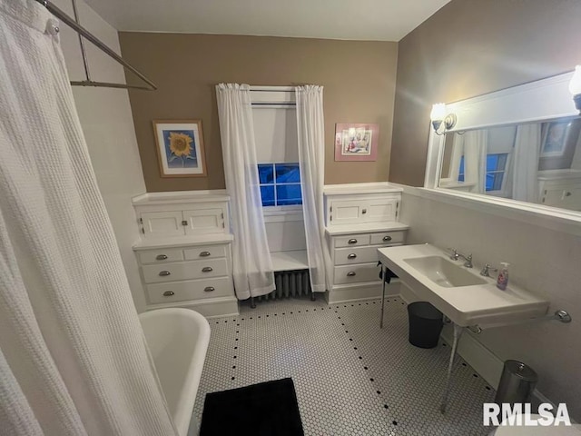 bedroom featuring light wood-type flooring, radiator, crown molding, and ceiling fan