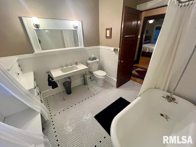 bathroom with tile patterned flooring, shower / bath combo, and sink