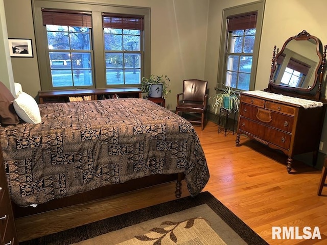 bedroom featuring hardwood / wood-style floors and vaulted ceiling