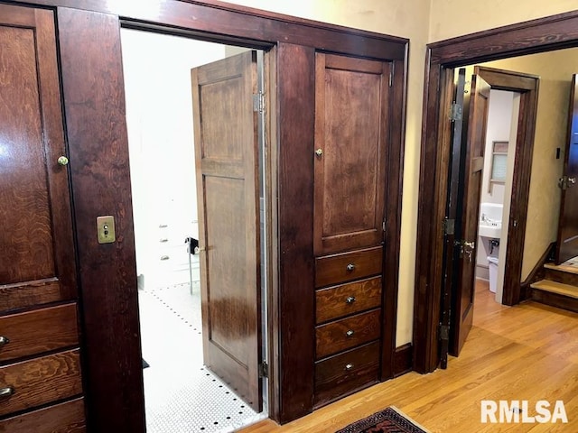 hallway with light hardwood / wood-style floors