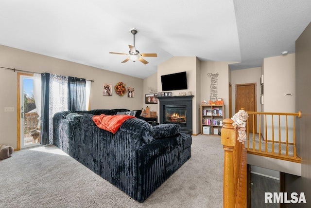 living room featuring ceiling fan, carpet floors, and vaulted ceiling