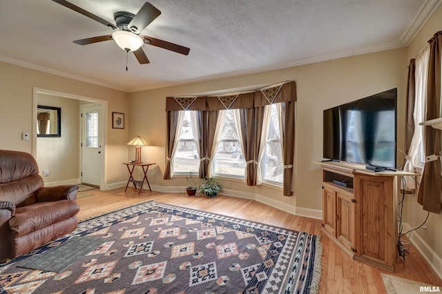 living room featuring ornamental molding, ceiling fan, and light hardwood / wood-style flooring