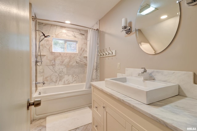 bathroom with shower / tub combo and vanity