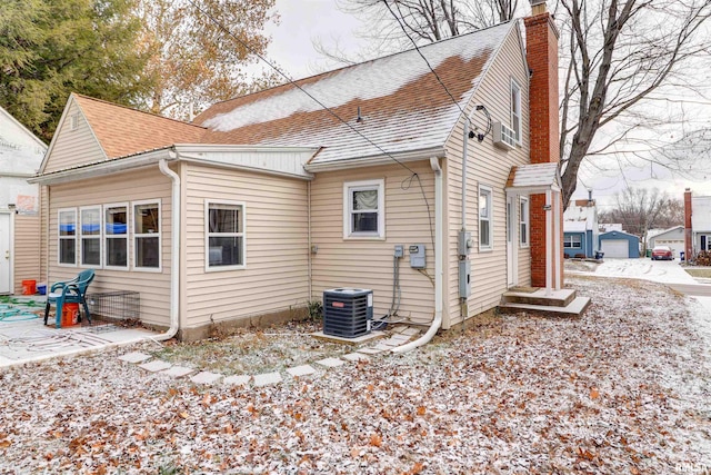 rear view of property featuring central AC unit