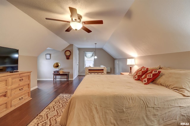 bedroom with vaulted ceiling, dark hardwood / wood-style flooring, a textured ceiling, and ceiling fan