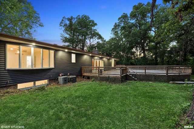 27339 Sherry Ann Ct, Donahue, IA 52746 - back of property featuring a wooden deck, a yard, and a chimney