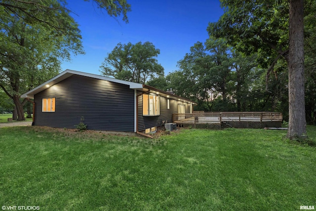 27339 Sherry Ann Ct, Donahue, IA 52746 - view of property exterior with a wooden deck and a lawn