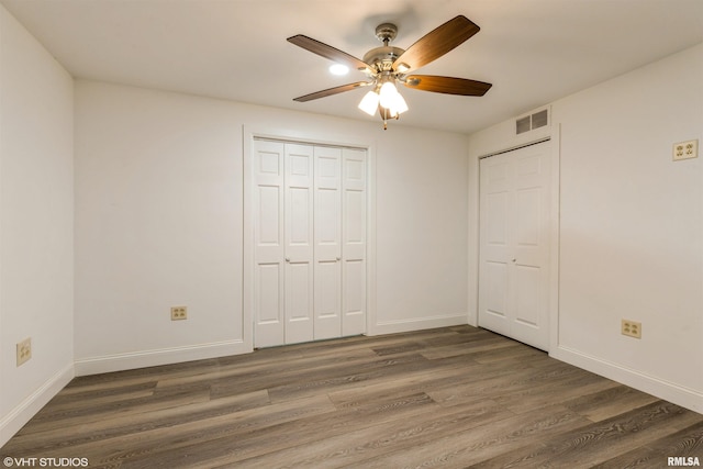 27339 Sherry Ann Ct, Donahue, IA 52746 - unfurnished bedroom featuring wood finished floors and a ceiling fan