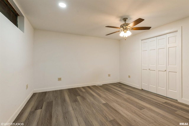 27339 Sherry Ann Ct, Donahue, IA 52746 - unfurnished bedroom with wood finished floors, a closet, a ceiling fan, and recessed lighting