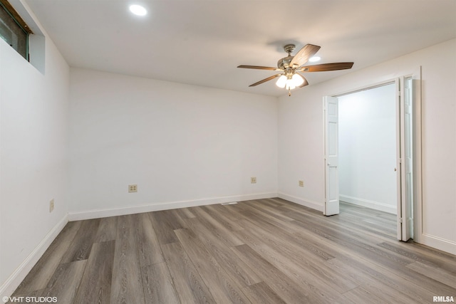 27339 Sherry Ann Ct, Donahue, IA 52746 - unfurnished bedroom featuring wood finished floors and ceiling fan