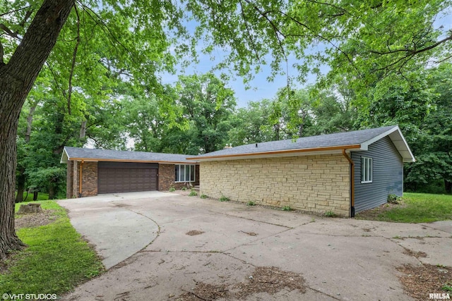 27339 Sherry Ann Ct, Donahue, IA 52746 - view of front of home featuring driveway, an attached garage, and brick siding