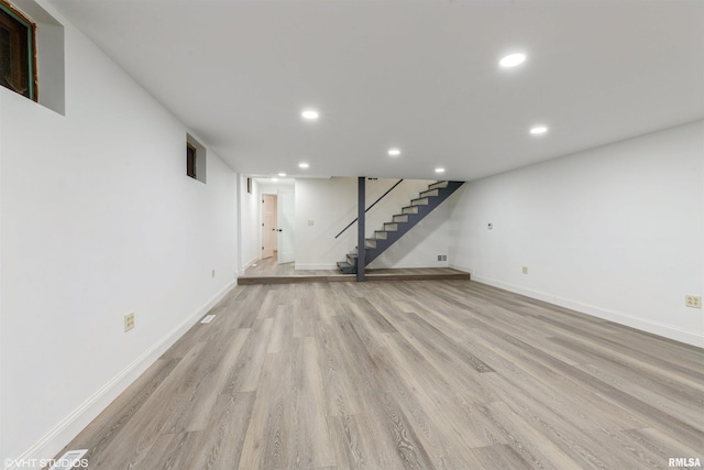 27339 Sherry Ann Ct, Donahue, IA 52746 - unfurnished living room featuring stairway, light wood-type flooring, and recessed lighting