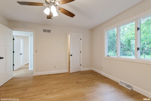 27339 Sherry Ann Ct, Donahue, IA 52746 - spare room with light wood-type flooring, a ceiling fan, and a smoke detector