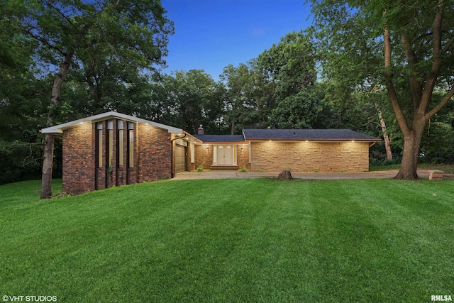27339 Sherry Ann Ct, Donahue, IA 52746 - back of house featuring a yard, an attached garage, and a chimney