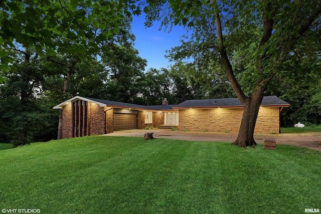 27339 Sherry Ann Ct, Donahue, IA 52746 - view of front of home featuring a garage, driveway, and a front lawn