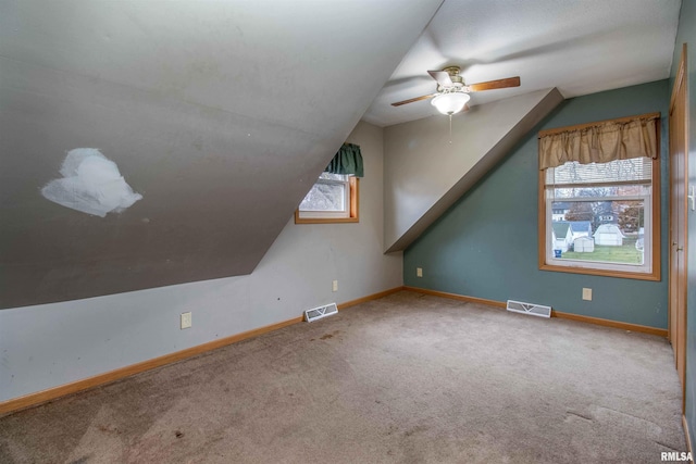 additional living space with carpet flooring, vaulted ceiling, and ceiling fan