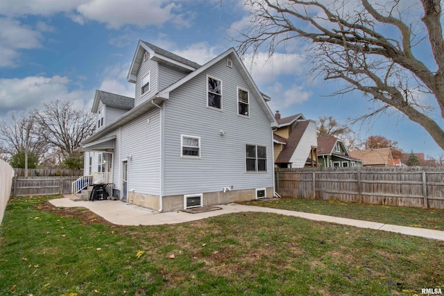 rear view of house with a yard