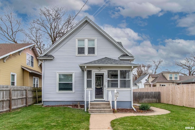 view of front of property featuring a sunroom and a front yard