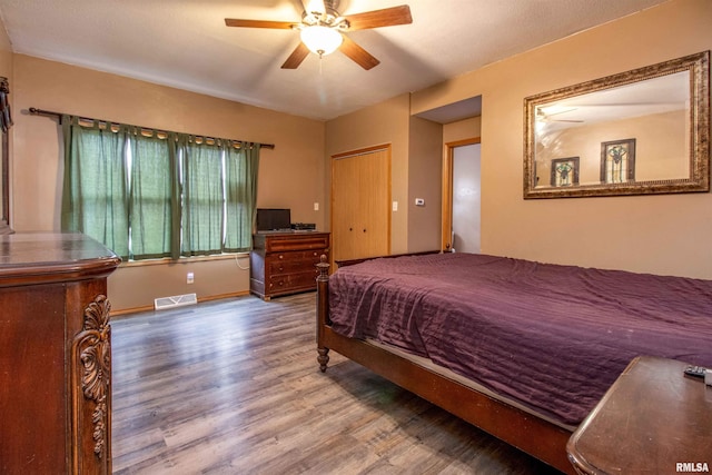 bedroom with ceiling fan and hardwood / wood-style floors