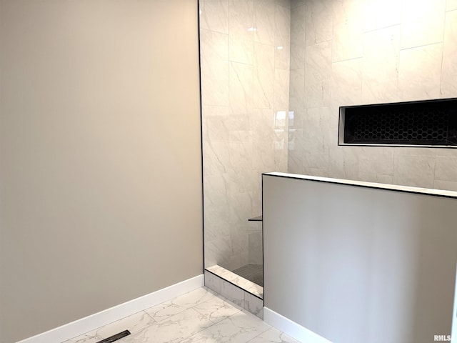 bathroom with tiled shower