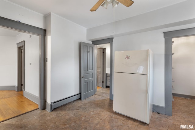 kitchen featuring white refrigerator, crown molding, ceiling fan, baseboard heating, and light hardwood / wood-style floors