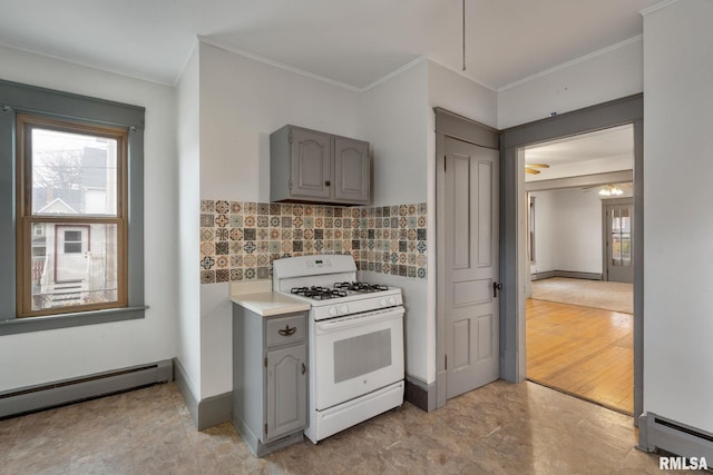 kitchen featuring gray cabinetry, decorative backsplash, a baseboard radiator, and white gas range oven