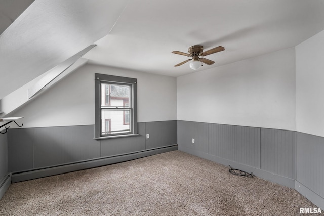 additional living space featuring carpet flooring, ceiling fan, lofted ceiling with skylight, and baseboard heating