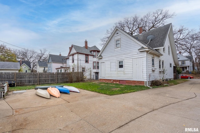 back of property featuring a yard