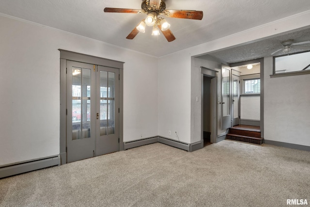 carpeted empty room featuring ceiling fan, crown molding, and a textured ceiling