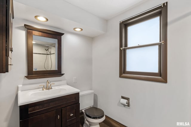 bathroom with vanity, toilet, and walk in shower