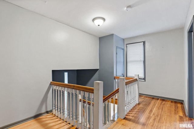 corridor with hardwood / wood-style floors