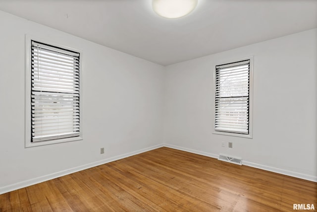 unfurnished room with wood-type flooring