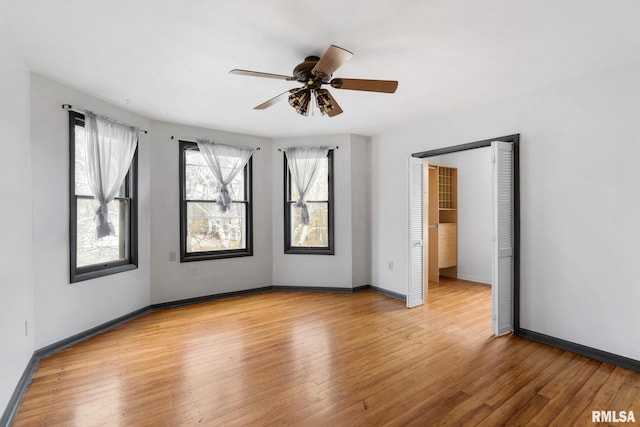 spare room featuring ceiling fan and light hardwood / wood-style flooring