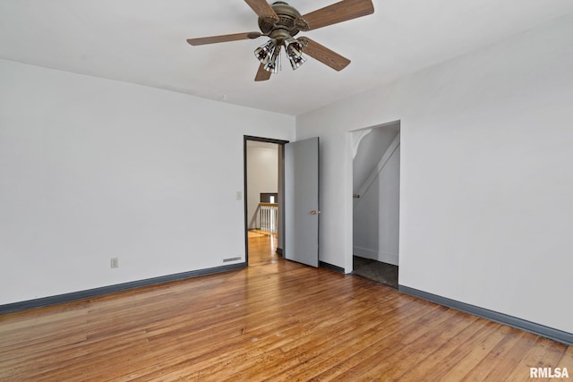 spare room featuring ceiling fan and light hardwood / wood-style floors