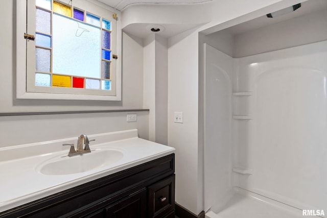 bathroom with a shower and vanity